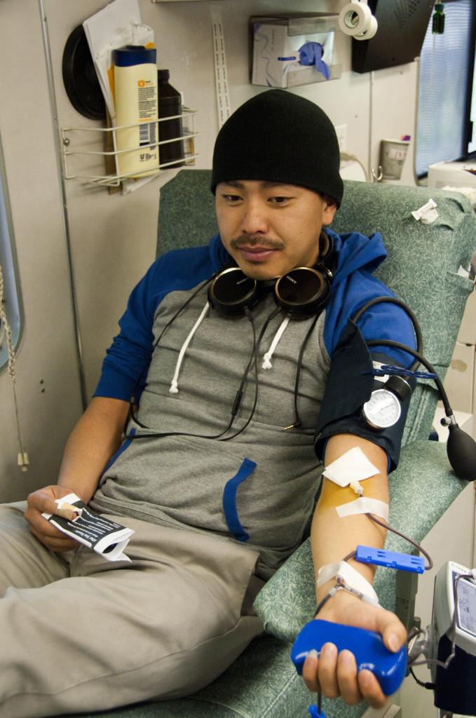 Biology major Jay Vue tries to relax as he donates, durring the Feb. 22 blood drive in the Gorton Quad. -David L. Wells, City Times