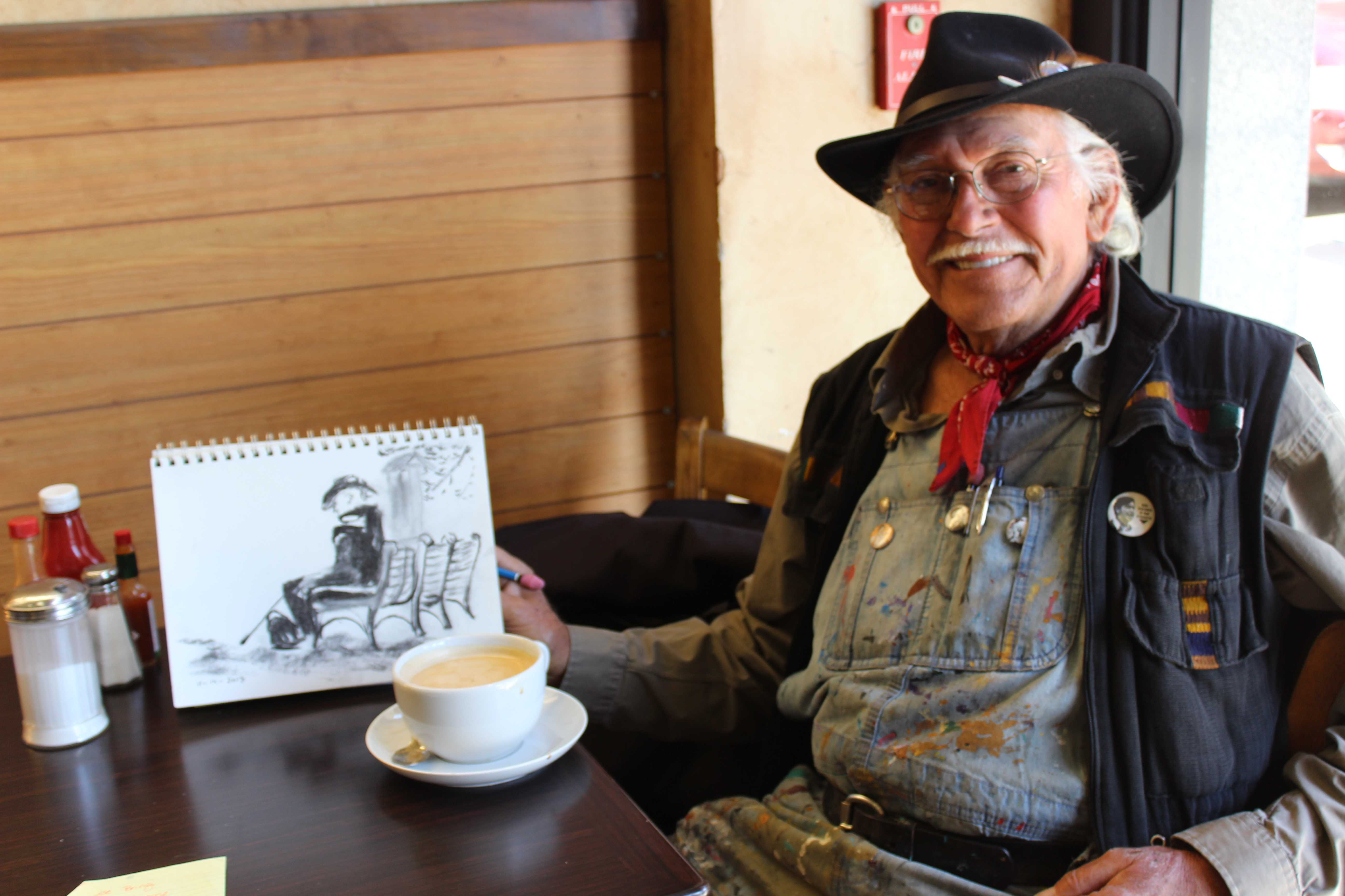 Salvador Torres works on his drawings at a local San Diego cafe in October.Photo credit: Andrew Hahn.
