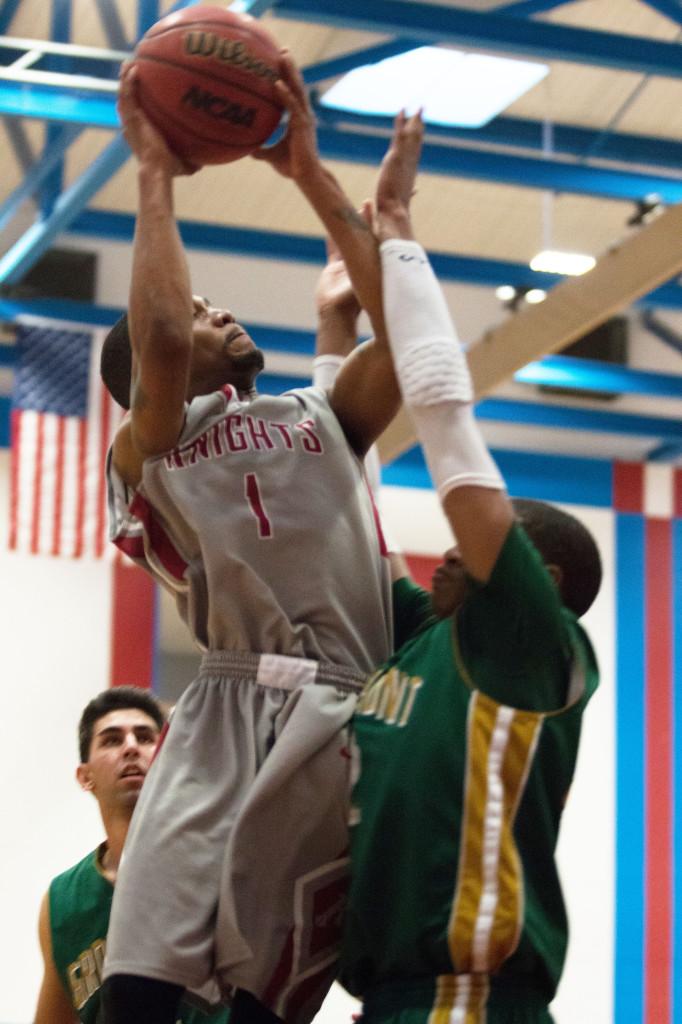 Point guard Martin Thomas skies over a Grossmont defender during the 76-69 win Feb. 14. (Photo courtesy of Xavier Besos)