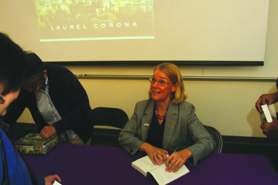 Humanities professor Laurel Corona with a copy of her latest book 
