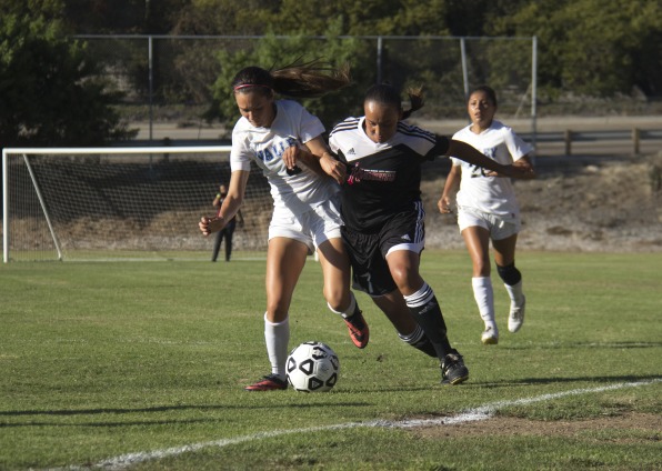 San Bernardino forward Veronica Parker (left) and City College midfielder Rebecca Garcia (right) fight to gain control of the ball during a home game at San Diego City College soccer field on Sept. 19.  Photo Credit: Celia Jimenez