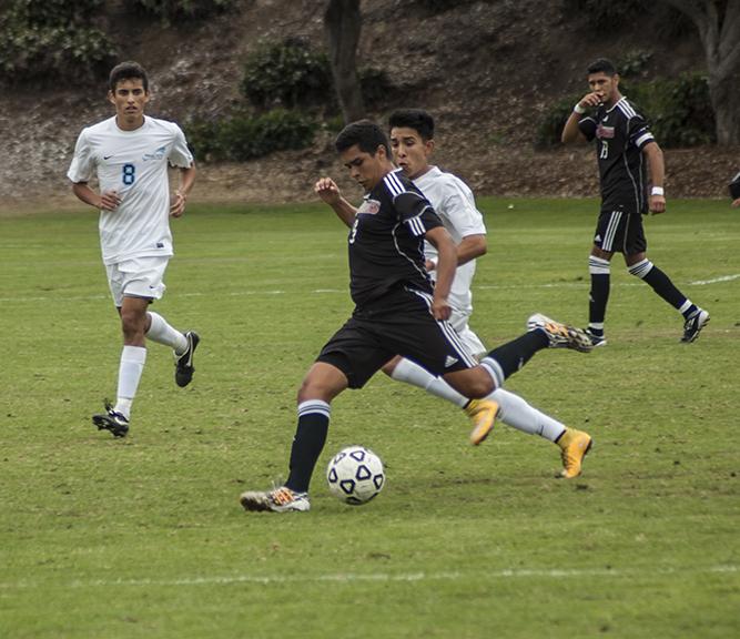 While attacking the MiraCosta defense sophomore midfielder Daniel Herrera crosses the ball to the other side of the field on Oct. 31 at the SDCC Soccer Field where both teams tied 0-0. Photo credit: David Pradel