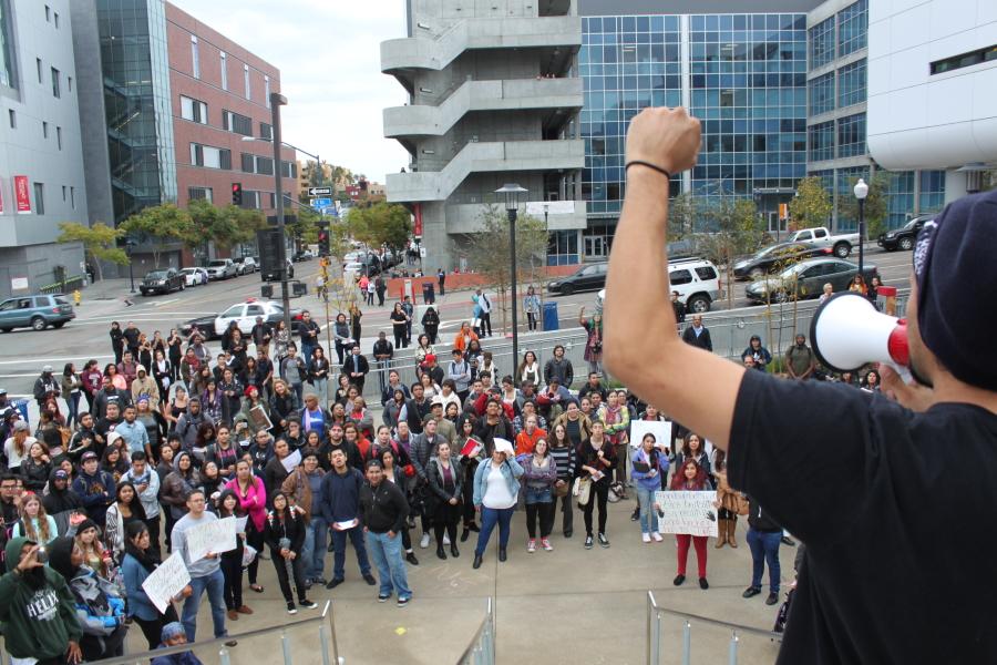 Student and Students in Power member Tony Perez raises his fist, leading the crowd that gathered in the BT Plaza in a chant of “We won’t take it anymore,” referring to recent officer-involved deaths that have and haven’t made national news. Photo credit: Miguel Cid