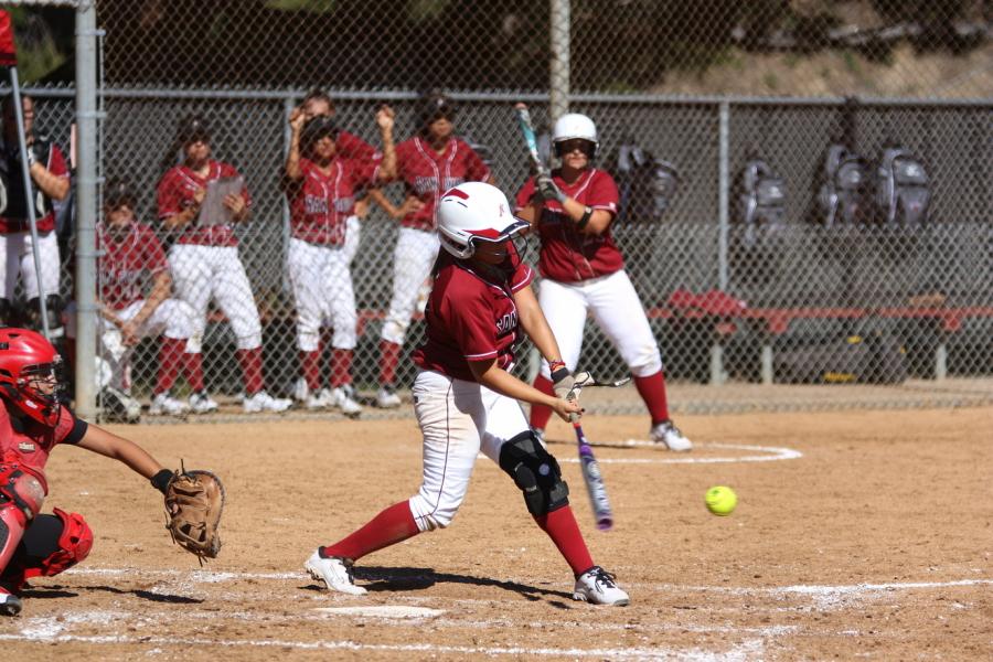 Freshman Ivana Gonzalez sends the ball flying during a home game against Long Beach City College on Feb. 7 where the Knights won 2-0 at the Betty Hock Softball Field. Photo credit: David Pradel