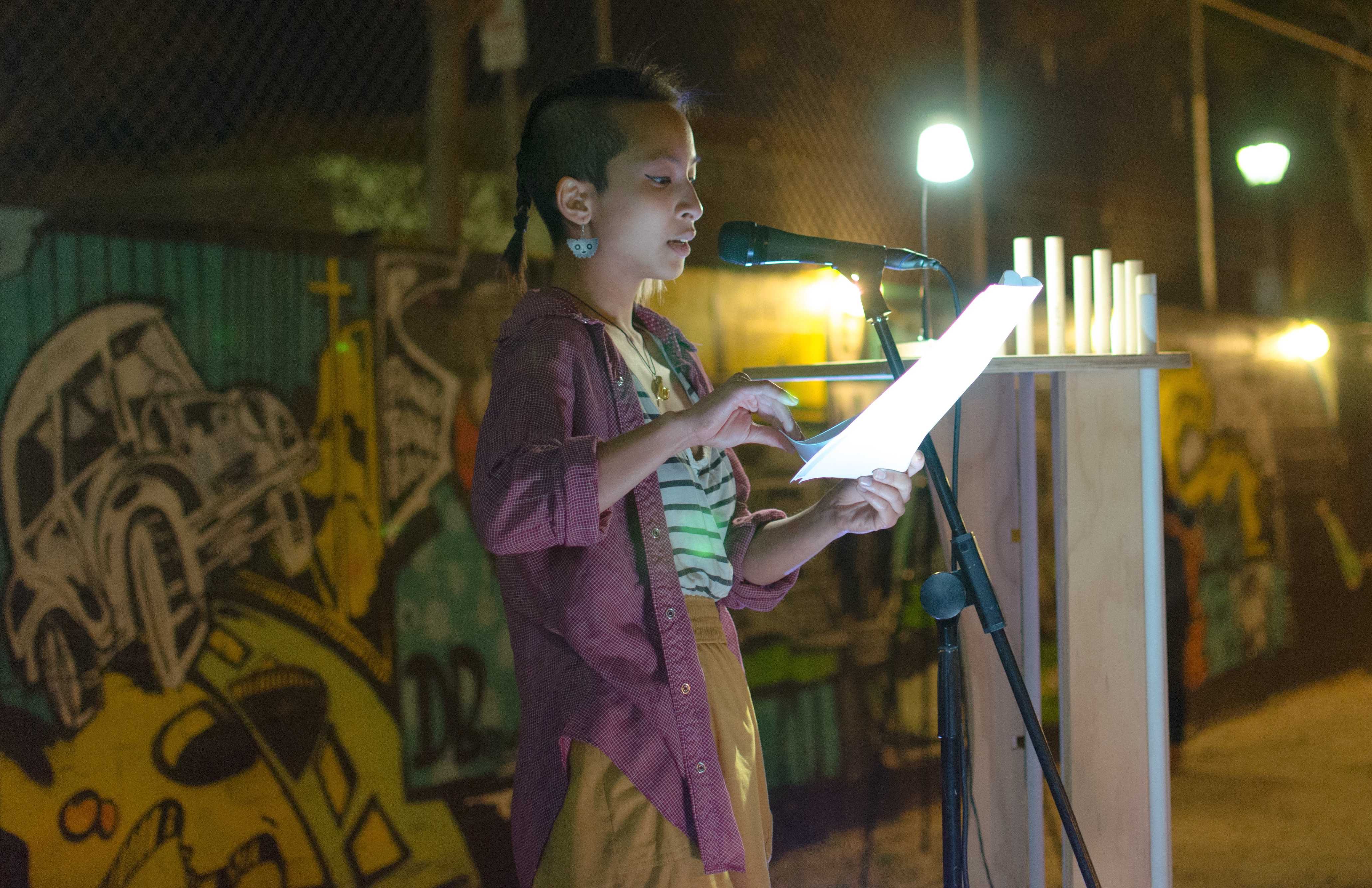 A VAMP participant reads her “taking a stand” inspired monologue during the VAMP showcase on March 26. City Times archive. Photo credit: Richard Lomibao