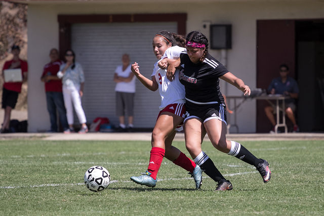 City College freshman midfielder Kassandra Herrera (number 9) and Santa Ana freshman forward  Kelly Becerra fight in the midfield for control of the ball at San Diego City College soccer field on Aug. 26. Photo by Celia Jimenez