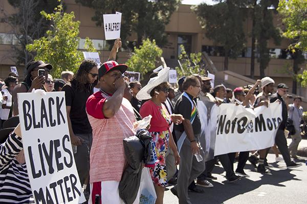 Community residents and faith leaders march Oct. 1 through downtown El Cajon to protest the killing of an unarmed African refugee by a city police officer. Photo by Celia Jimenez / City Times