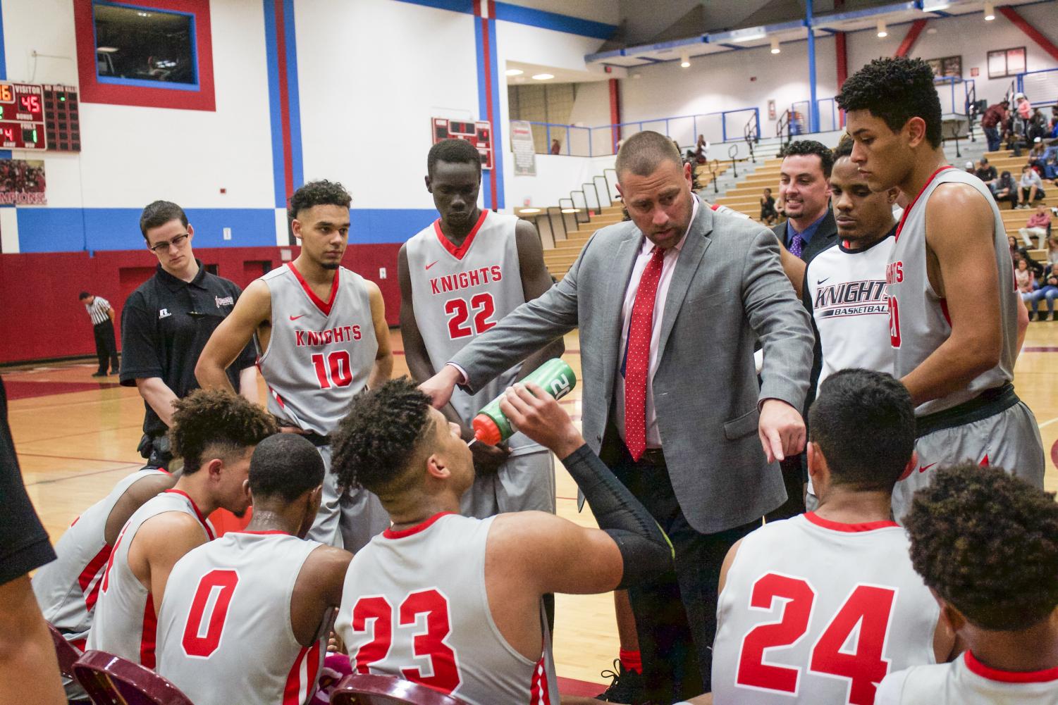 Coach Mitch Charlens talks to the team during a time-out to go over his final thoughts to take home another win. 