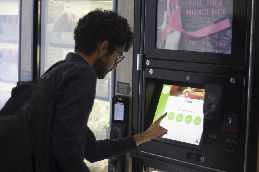 A City College student uses the Smart Market Vending machine.