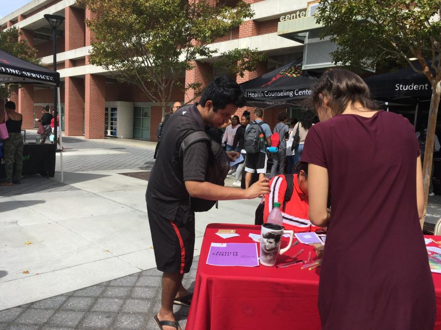 A City College Student participates in activity at a booth during the Suicide Prevention Fair.