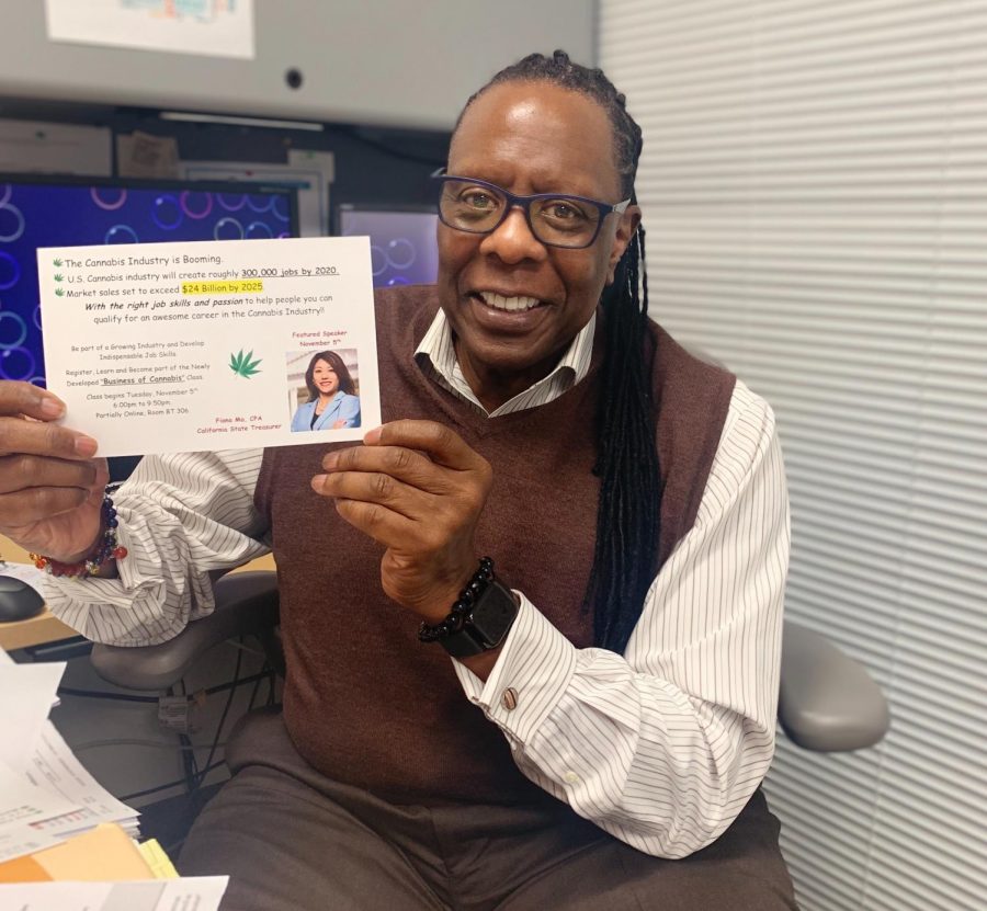 Dr. Leroy Brady holds up a flier for his new Business of Cannabis class.