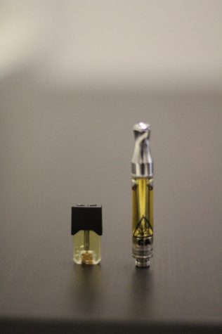 A nicotine vape pod alongside a THC vape pod