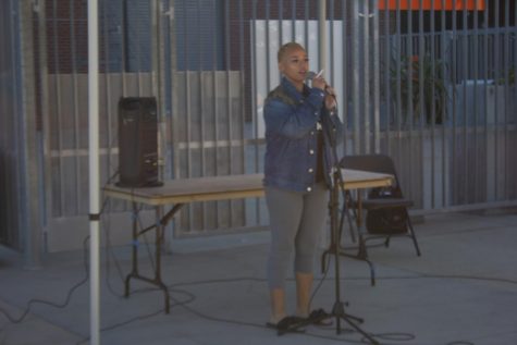 Women wearing a blue jacket, performing at City College.