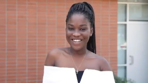 Associated Students Government president Victoria Owusu stands smiling in front of a brick background