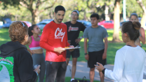 Knights women’s X-C team head coach Marcus Anzures discusses plans with the team at the last team run practice before their State championship bid. 