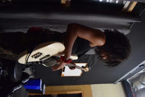 Ada Ngozi plays bass guitar