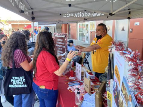 Rudy Juarez interacts with students at the City library tent at Fall Fest