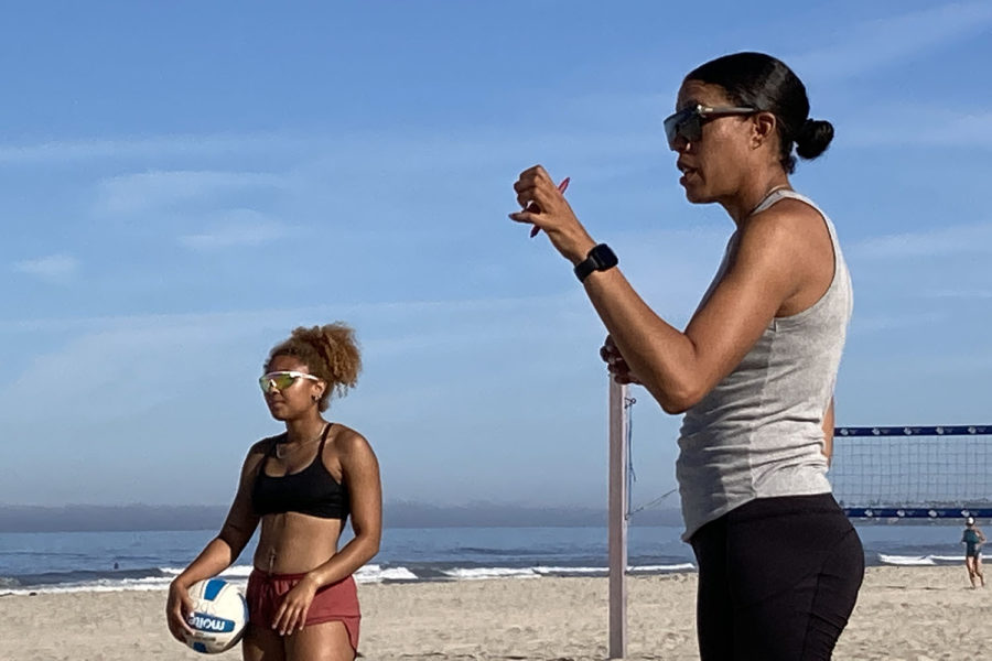 Faith Patterson (left) and Audra Dent stand by volleyball nets at Mission Beach