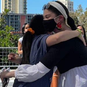 Kaitlyn Moore hugs her younger sister on the A building patio at San Diego City College