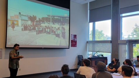 Saul Flores (left) presenting an image of his trip to his mother’s hometown school in Mexico to the audience 