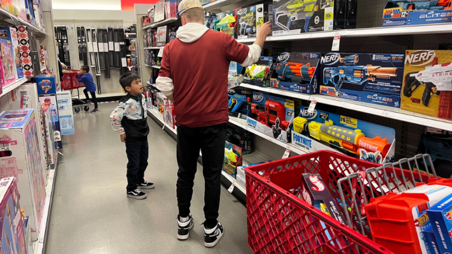 City College athletes help children sponsored by the Shop with a Jock spree pick out toys.