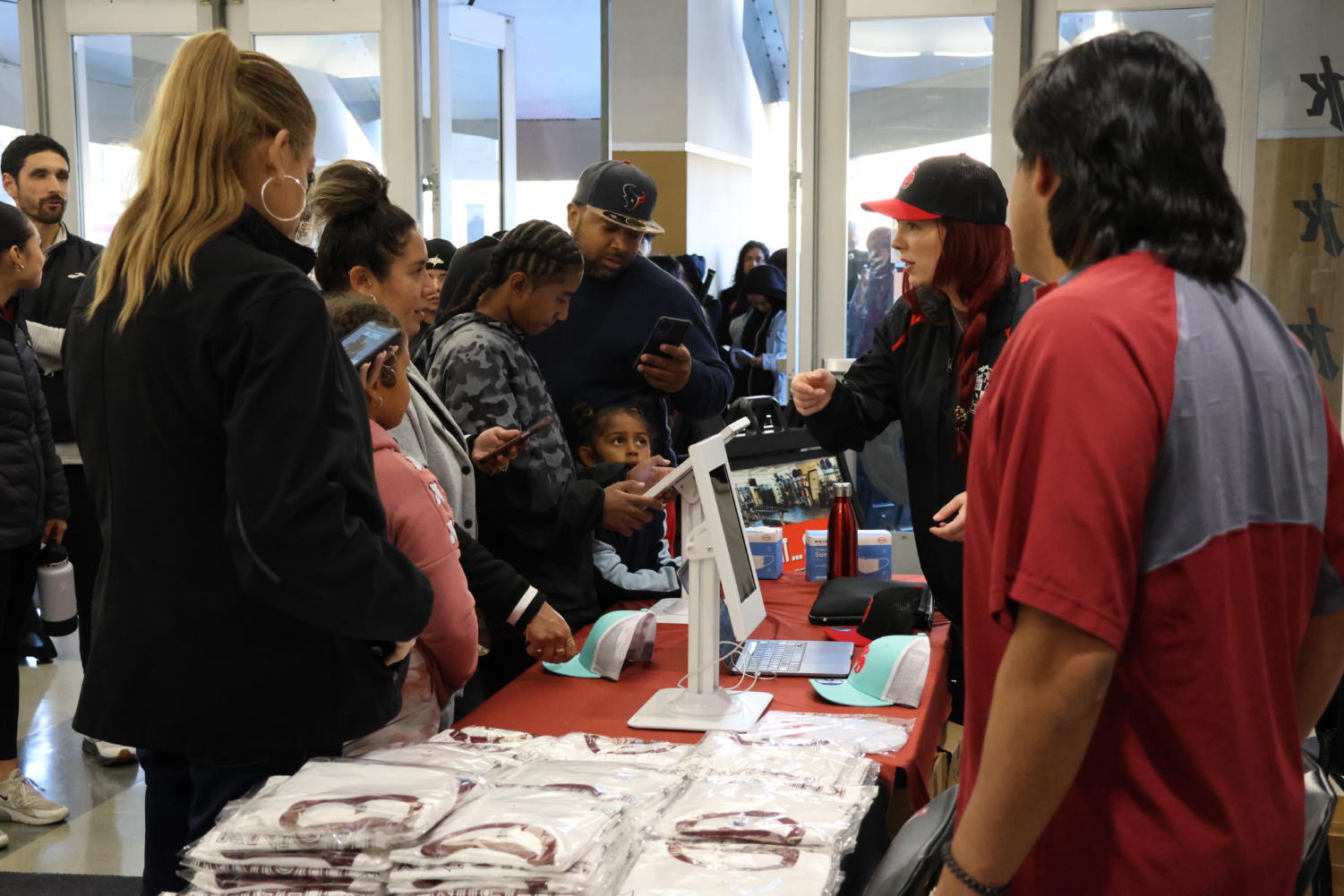 A line forms for giveaway items inside the Harry West Gym