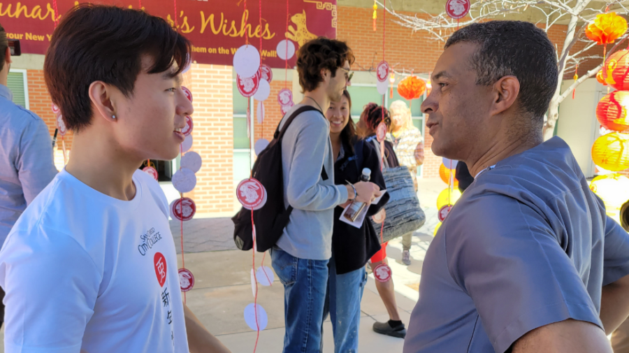Thomas Tsai, president of the Asian & Pacific Islander Student Alliance (APSA), left, talks with San Diego City College President Ricky Shabazz