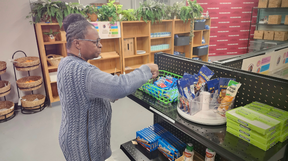 Marie Lindsey, Knight’s Table administrative assistant, restocks shelves with snacks available for students at City College’s food pantry Tuesday, March 14, 2023. Photo by Sven Domingos/City Times Media