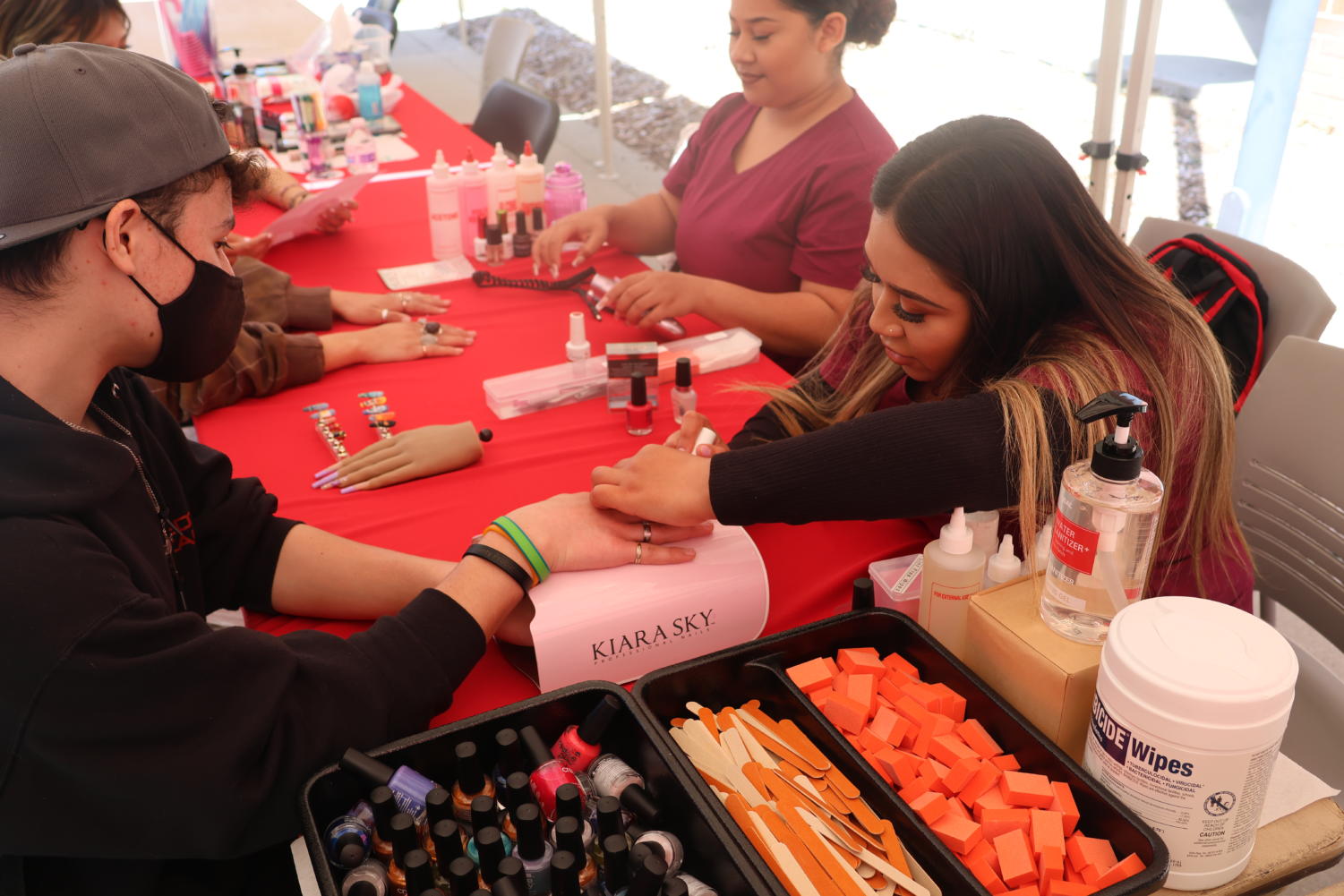Nail tech student Isabel Vazquez paints Darien Hueso’s nails while on a San Diego High School visit to City College’s open house, April 20, 2023. Photo by Joel Nevarez/City Times Media