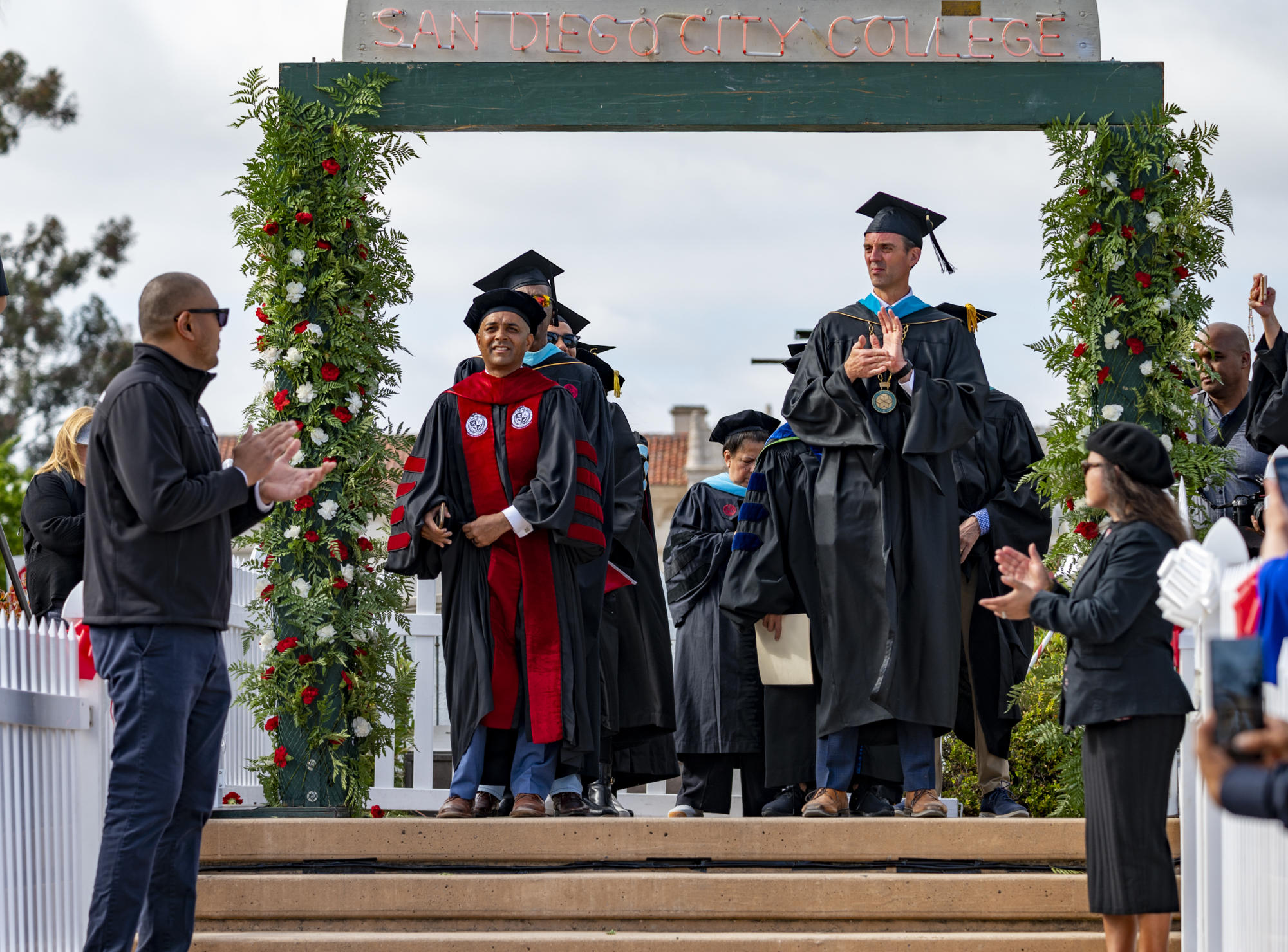 City College President Ricky Shabazz, left, and SDCCD Acting Chancellor Greg Smith, right, stand under the graduation ceremony archway at the San Diego City College commencement ceremony, May 25, 2023. Photo courtesy of San Diego City College Flickr