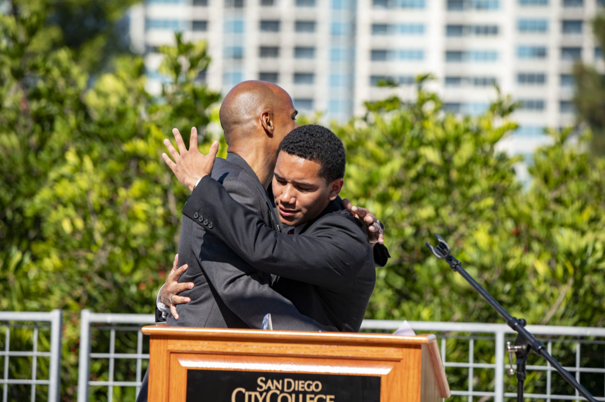 Vice President of Administrative Services John Parker, left, embraces ASG President Diego Bethea, right, after receiving the Golden Pillar Award during the Fall 2023 Convocation at City College, August 17, 2023. The award recognizes outstanding administrators at City College. Photo courtesy of City Communications