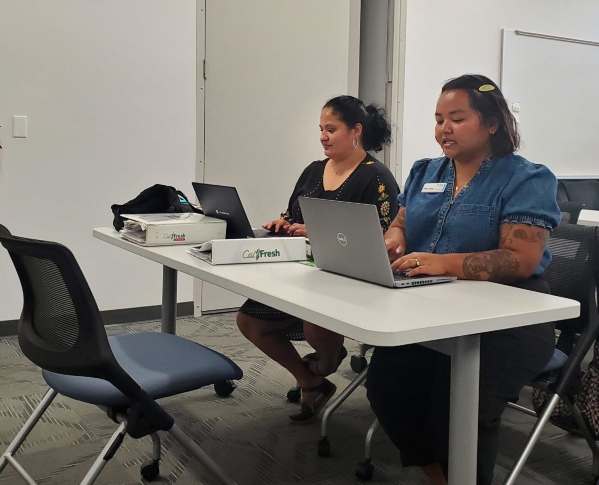 CalFresh Outreach Specialist Lizbeth Jimenez, left, and CalFresh Outreach Coordinator Molly Thong, right, prepare to assist students with their CalFresh questions and needs on Sept. 14, 2023. Photo by Kevin Ouellette/City Times Media
