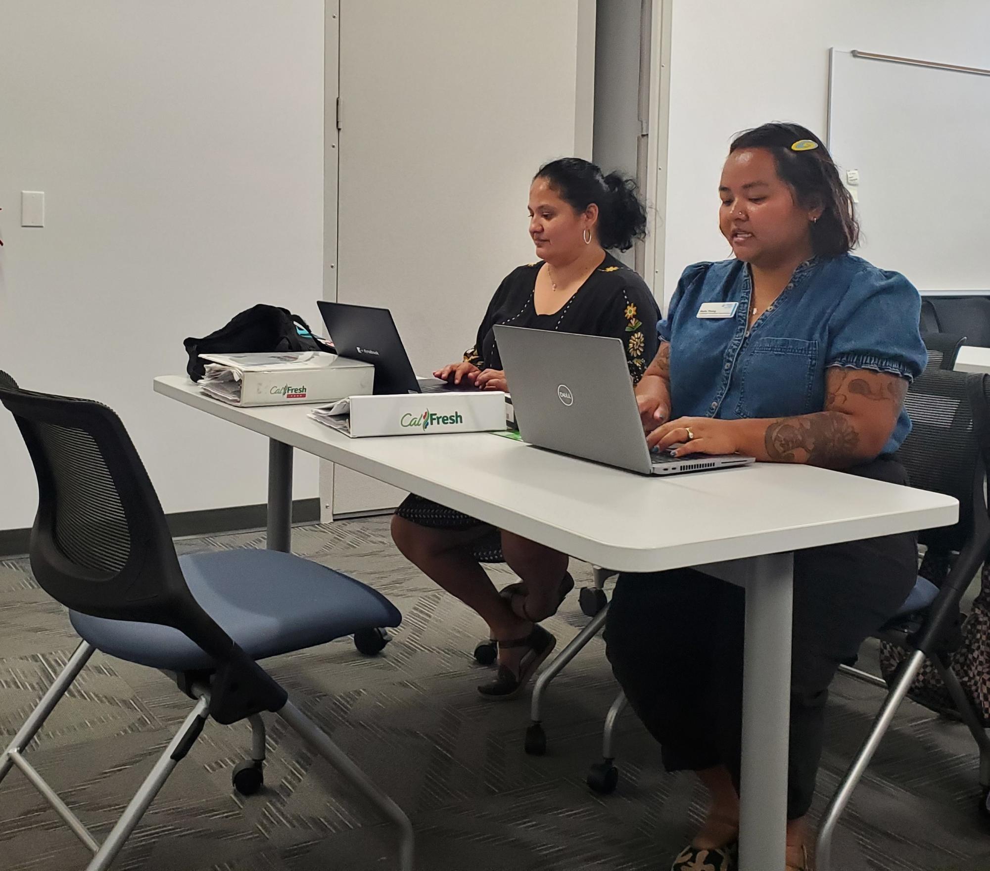 CalFresh Outreach Specialist Lizbeth Jimenez, left, and CalFresh Outreach Coordinator Molly Thong, right, prepare to assist students with their CalFresh questions and needs on Sept. 14, 2023. Photo by Kevin Ouellette/City Times Media
