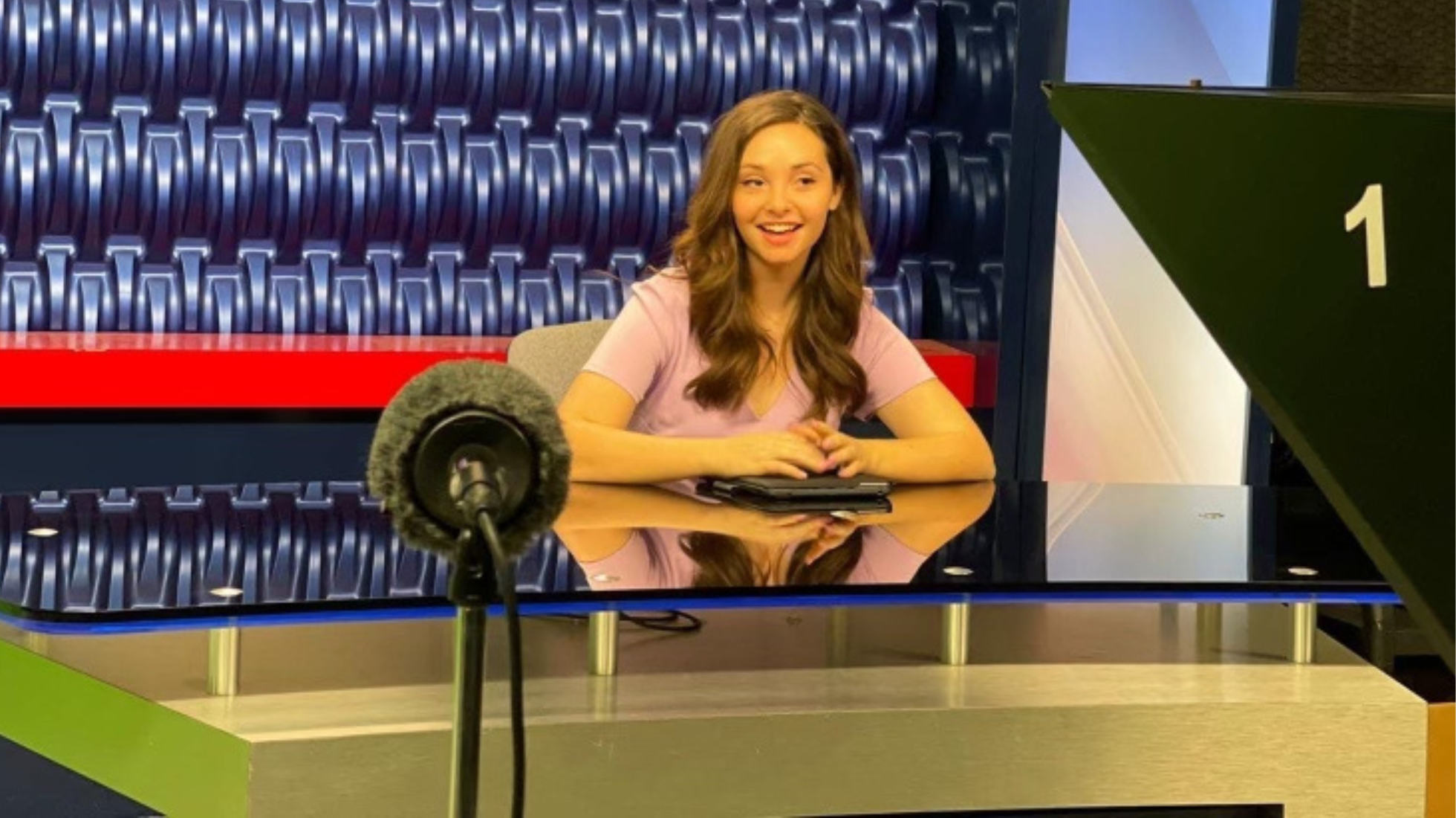 Jillian Fortner, pictured at the Newscene anchor desk in the City Times Media studio, started her career with CCTV in 2021. Photo courtesy of Jillian Fortner