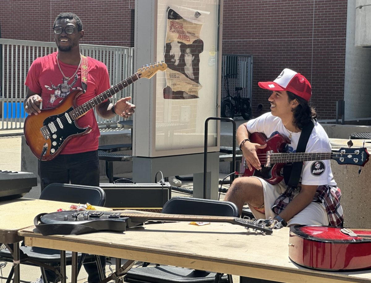 Bernard (Bernie) Clark, left, and Miguel Samaniego, right, take a break from playing to recruit students to the Music Club at the City Club Rush Carnival, August 24, 2023. Photo by Bailey Kohnen/City Times Media
