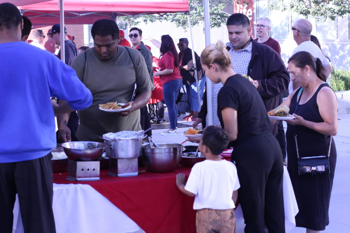 Family members fill their plates with tacos and condiments at the Noche de Familia event, September 20, 2023. Photo by Keila Menjivar/City Times Media