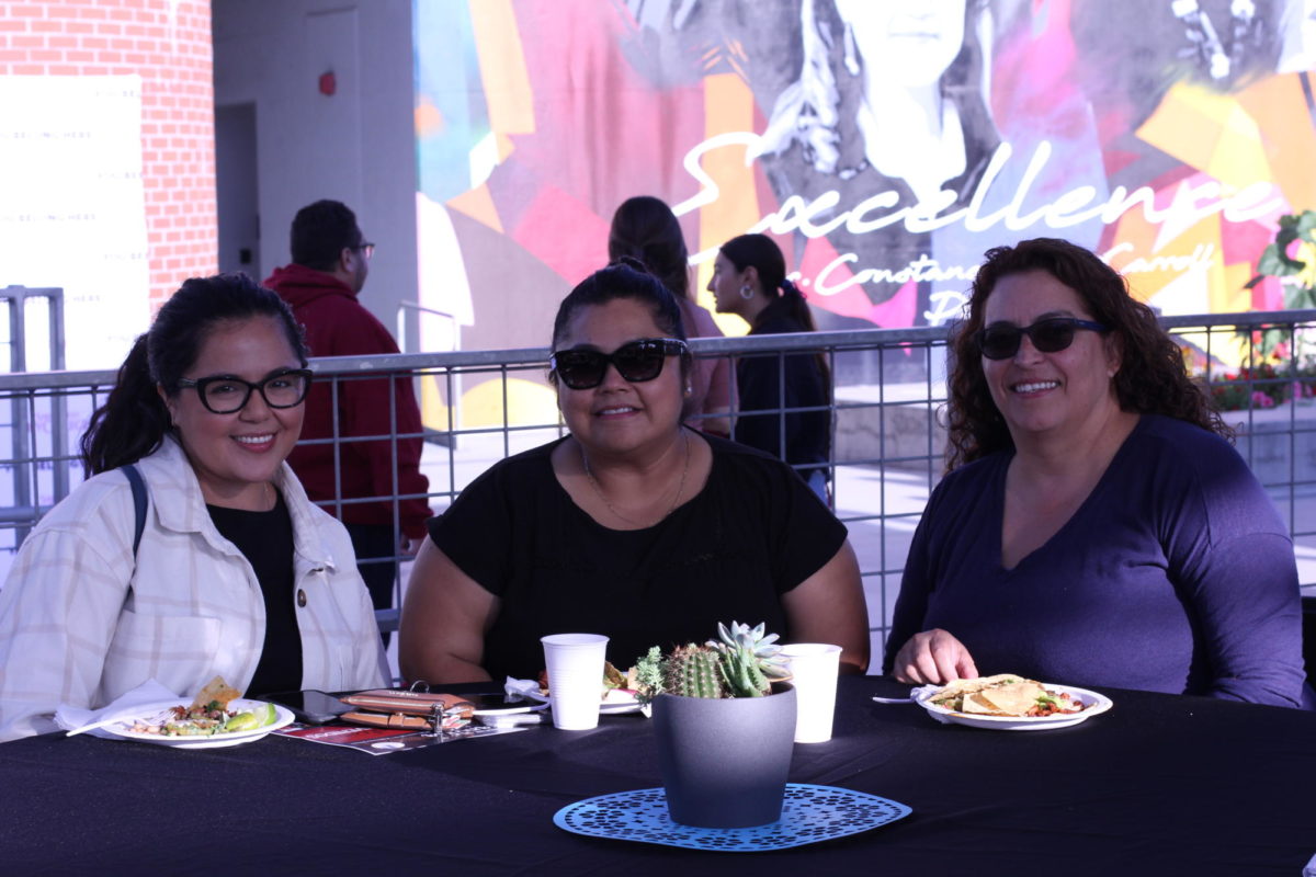 Sisters Nadia Pineda, left, and Susanna Dias, right, join their sister Selene Guittierez, center, a returning psychology student at the Noche de Familia event, September 20, 2023. “It’s very important to not just be present at home but it’s just, the ability that we have to come on campus and be able to share a meal and be together, it makes it more real for us to be able to see her move across campus and know that she’s on this journey but also feel celebrated as a Latina, ” Nadia Pineda said. Photo by Keila Menjivar/City Times Media