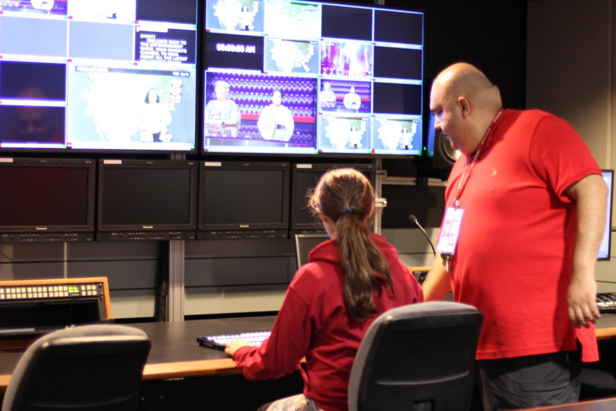 Chris Acedo, a radio, television and film professor, shows high school student Ecco Crocket how to work behind-the-scenes in a TV studio, September 20, 2023. Photo by Keila Menjivar/City Times Media