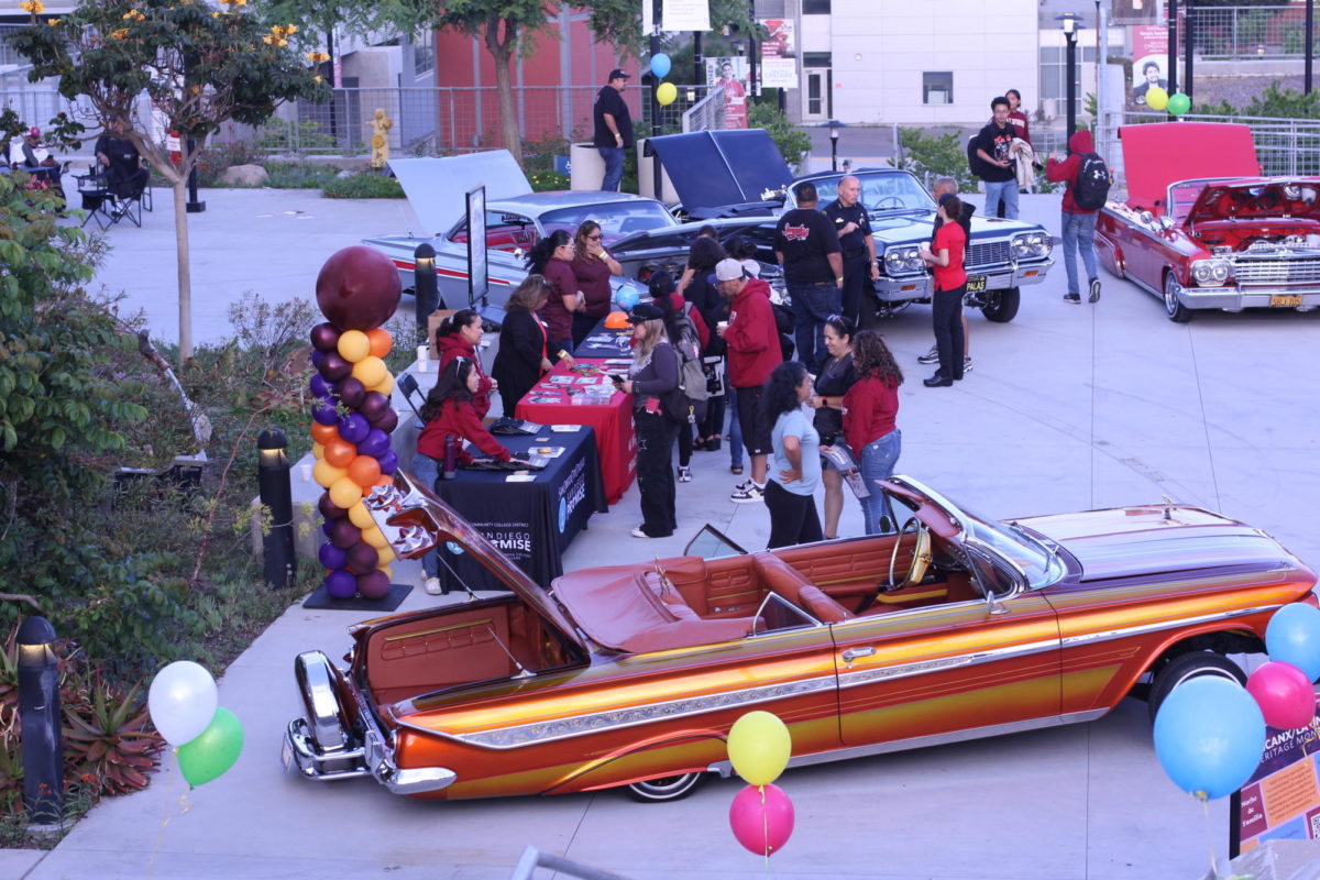 Current and prospective students and families explore the lowrider show and chat with the EOPS and Promise Program booths at the Noche de Familia event, September 20, 2023. Photo by Keila Menjivar/City Times Media