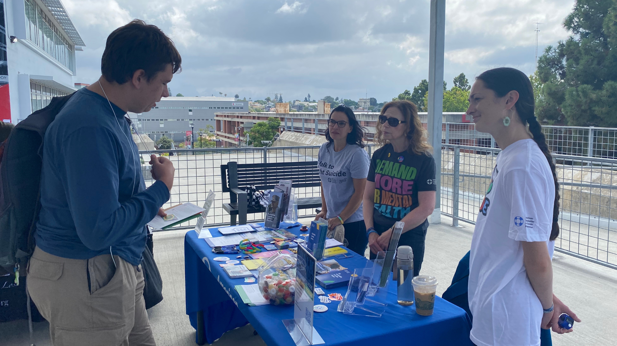 Thomas Waters, left, an environmental engineering major at City College, talks with, from left, Silvia Mohr, Barbara Shurgot and Jessie Allendorf representing the American Foundation for Suicide Prevention, September 18, 2023. Photo by Eve McNally/City Times Media