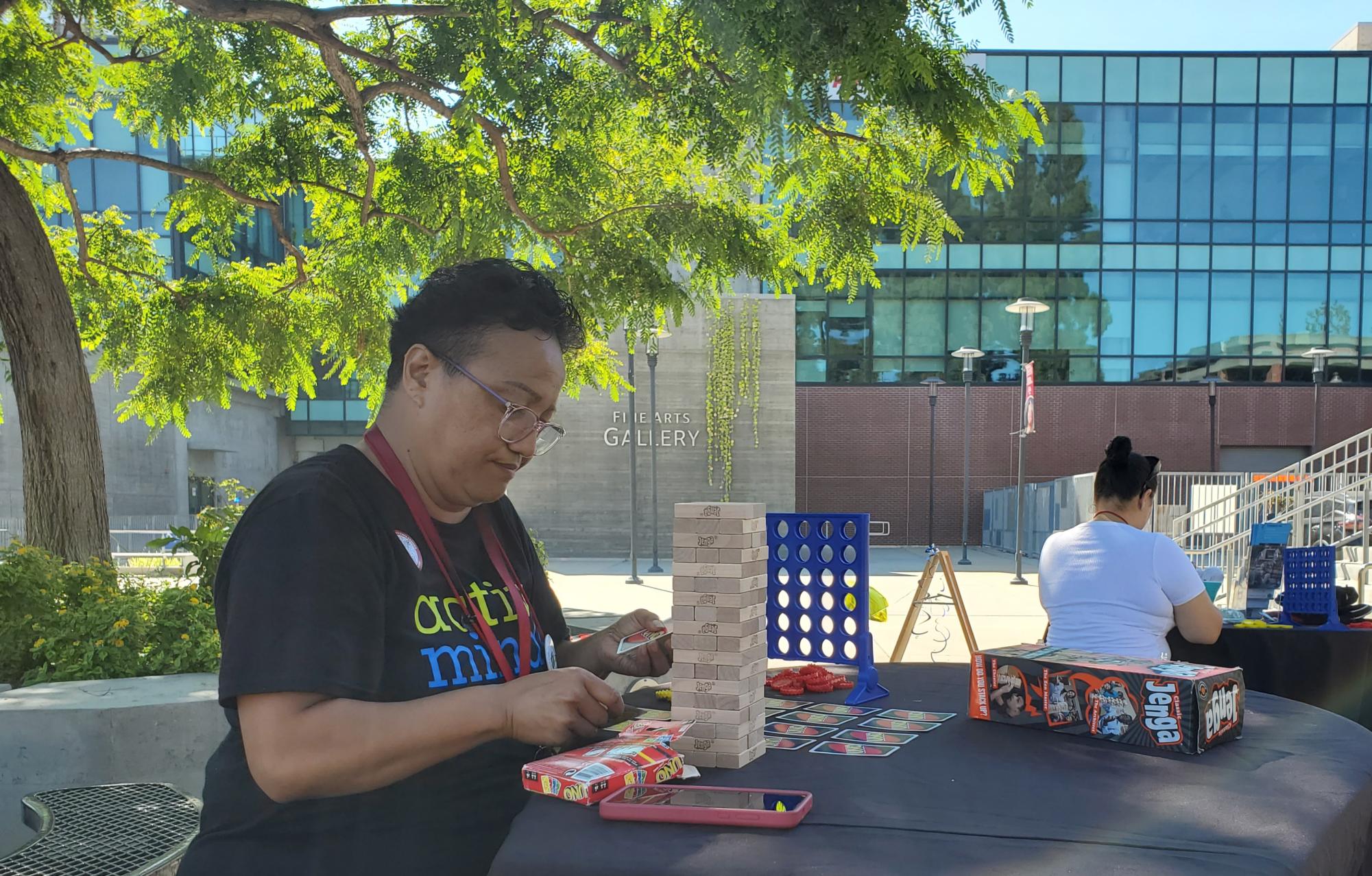 Liberal Arts and Black Studies student Sara Tiumalu sets up games for a Mental Health Services event on campus, Oct. 19, 2023. Sara is one of over 40 million holders of student loans. Photo by Kevin Ouellette/City Times Media
