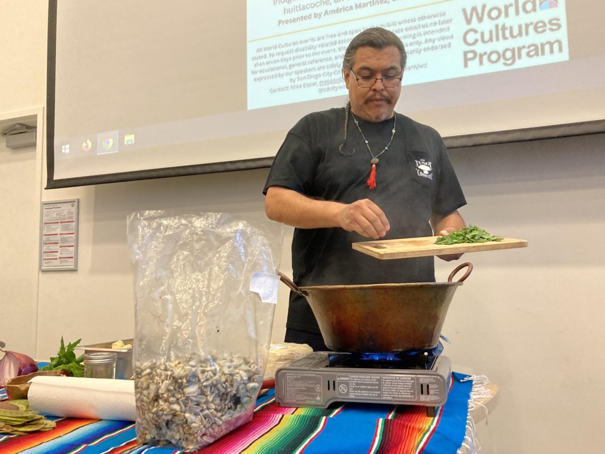Mario Ceballos, founder of the POC Fungi Community, slides chopped garlic into a cazo, while a bag of huitlacoche sits on the table during the food preparation part of “Indigenous Food Sovereignty: Discussion & Food Demonstration with Huitlacoche,” Wednesday, Oct. 18, 2023. Photo by Marco Guajardo/City Times Media