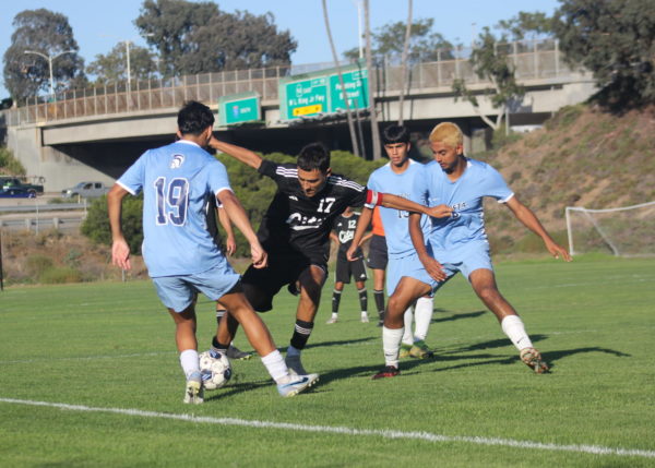 City College midfielder Isaac Velazquez (17), center, fights for the ball against MiraCosta players Isaac Ramos (19), left, and Leo Ayala (2), right, at their home game, Oct. 17, 2023. Photo by Sean Monney/City Times Media