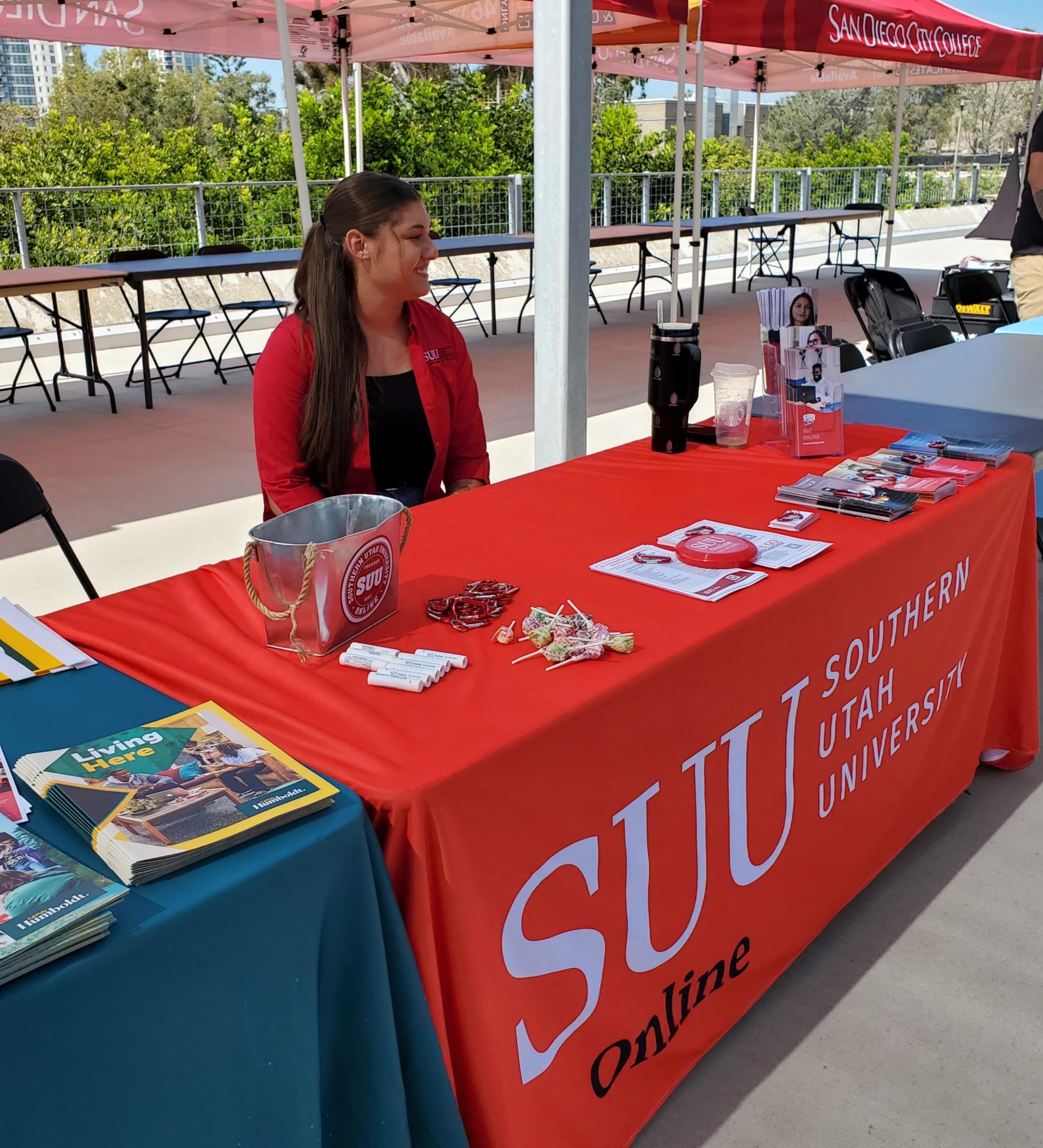 Southern Utah University student Shayla Piccini sits at her table ready to share resources and information about SUU’s online programs, Oct. 17, 2023. Photo by Kevin Ouellette/City Times Media