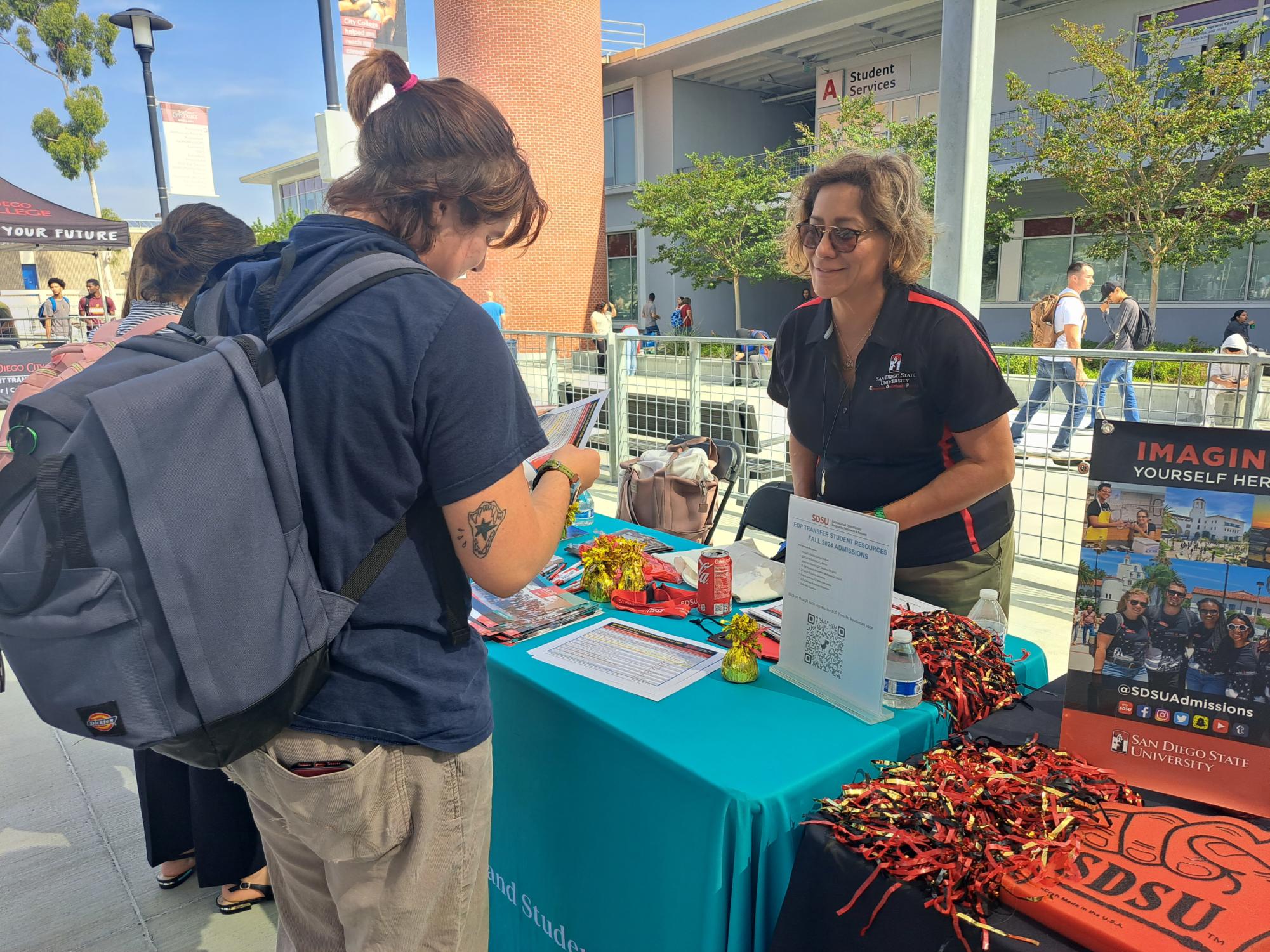 Nate Bartley, left, a 19-year-old City College theater major, looks at the information about transferring to San Diego State University. SDSU EOP Outreach, Recruitment and Admissions rep Lorena Malo, right, explains to Bartley how the transfer process works, Oct. 17, 2023. Photo by Luz Jaimes/City Times Media