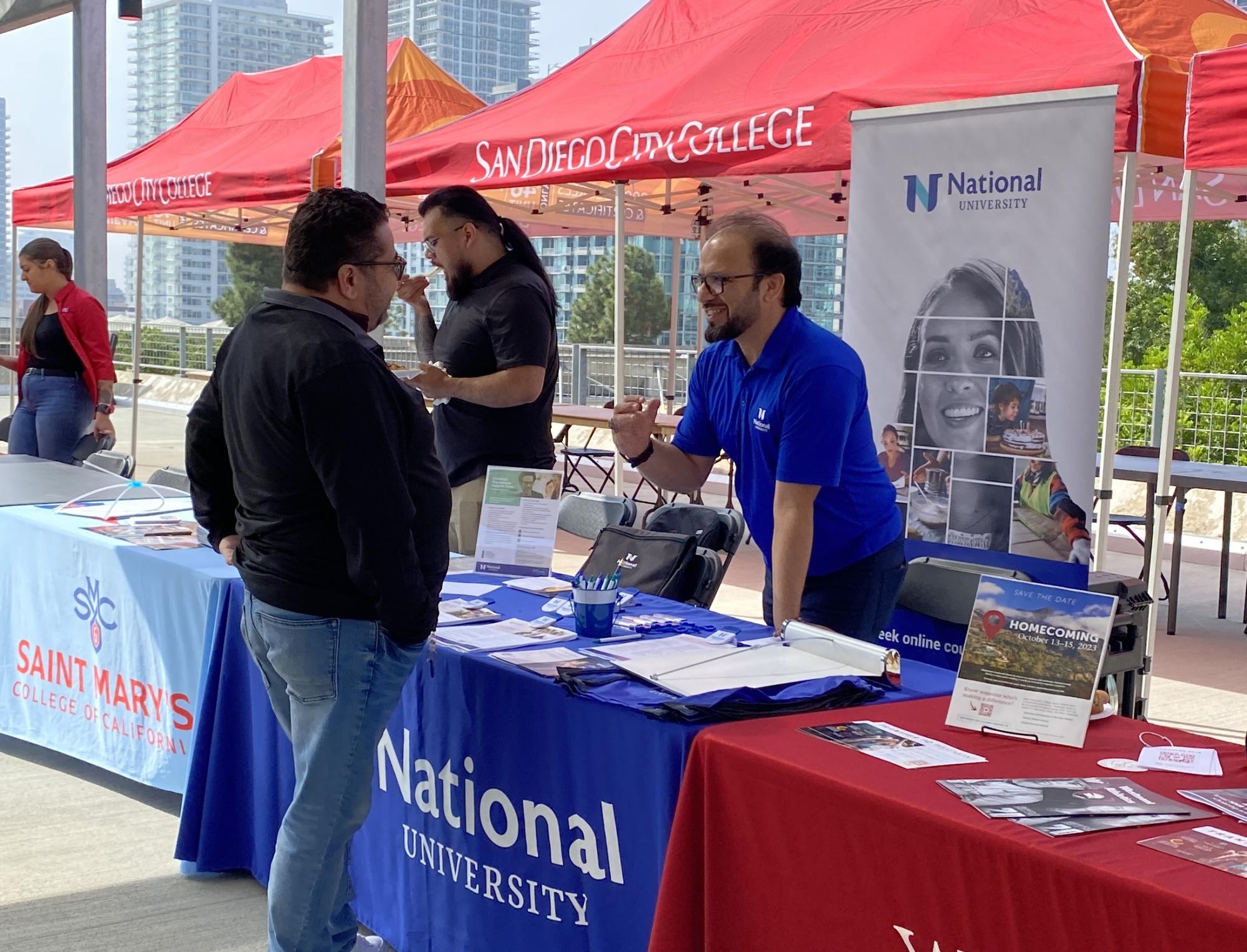 Vice President Student Services Marciano Perez, left, talks to Manager of Community College Pathways at National University Monir Masoud, right, at the City College Transfer Fair, Oct. 17, 2023. Photo by Luke Bradbury/City Times Media