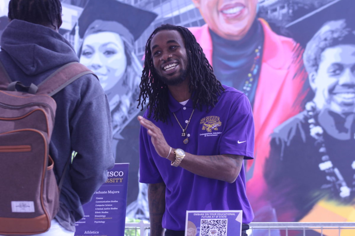 San Francisco State University recruiter Dereice Dawson, right, speaks to City College student David Agboola, left, at the City College Transfer Fair, Oct. 17, 2023. Photo by Sean Monney/City Times Media