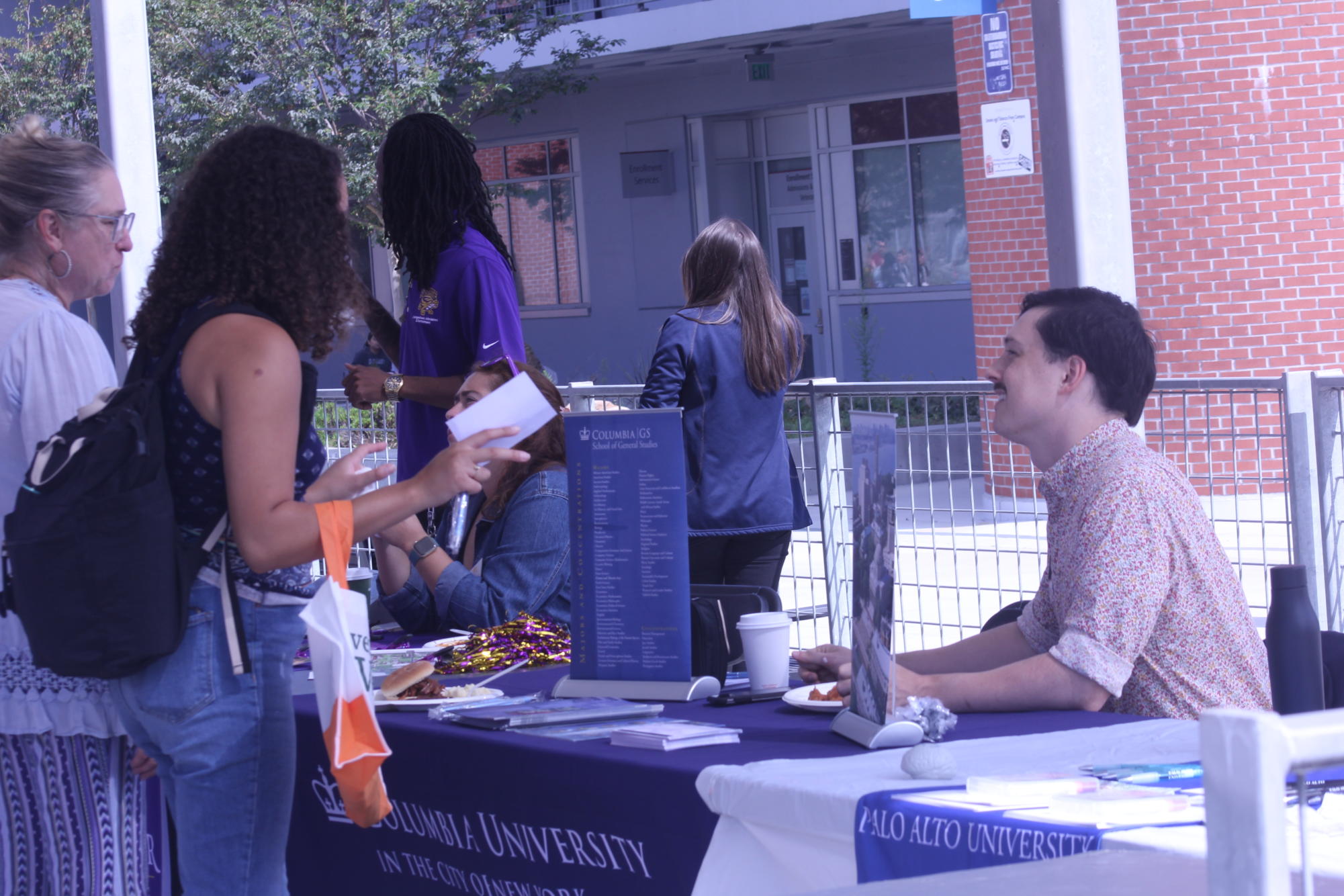 Columbia University School of General Studies representative Emmett Ingram, right, speaks to City College student Tyra Lawley, left, and Gwendolyn Kesler, far left, at the City College Transfer Fair, Oct. 17, 2023. Photo by Sean Monney/City Times Media