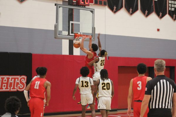 City College sophomore guard Alex Crawford dunks the ball in front of Chabot defender Isaiah Harper in the Knights 89-74 victory over the Gladiators in Harry West Gym on Thursday, Nov. 9, 2023. Photo by Sean Monney/City Times Media