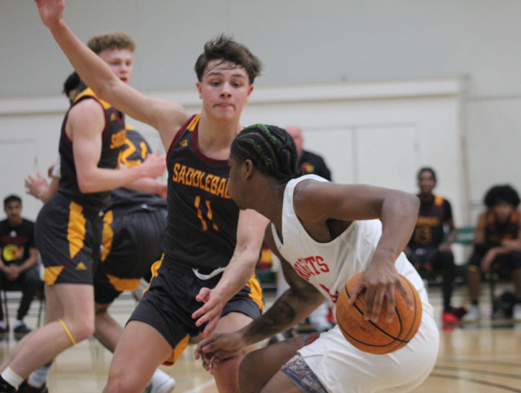 Sophomore starting guard KJay Bradley maneuvers around Saddleback College guard Hayden Fletcher during the Knights men’s basketball game at the Grossmont College Tournament, Dec. 1, 2023. Photo by Sean Monney/City Times Media